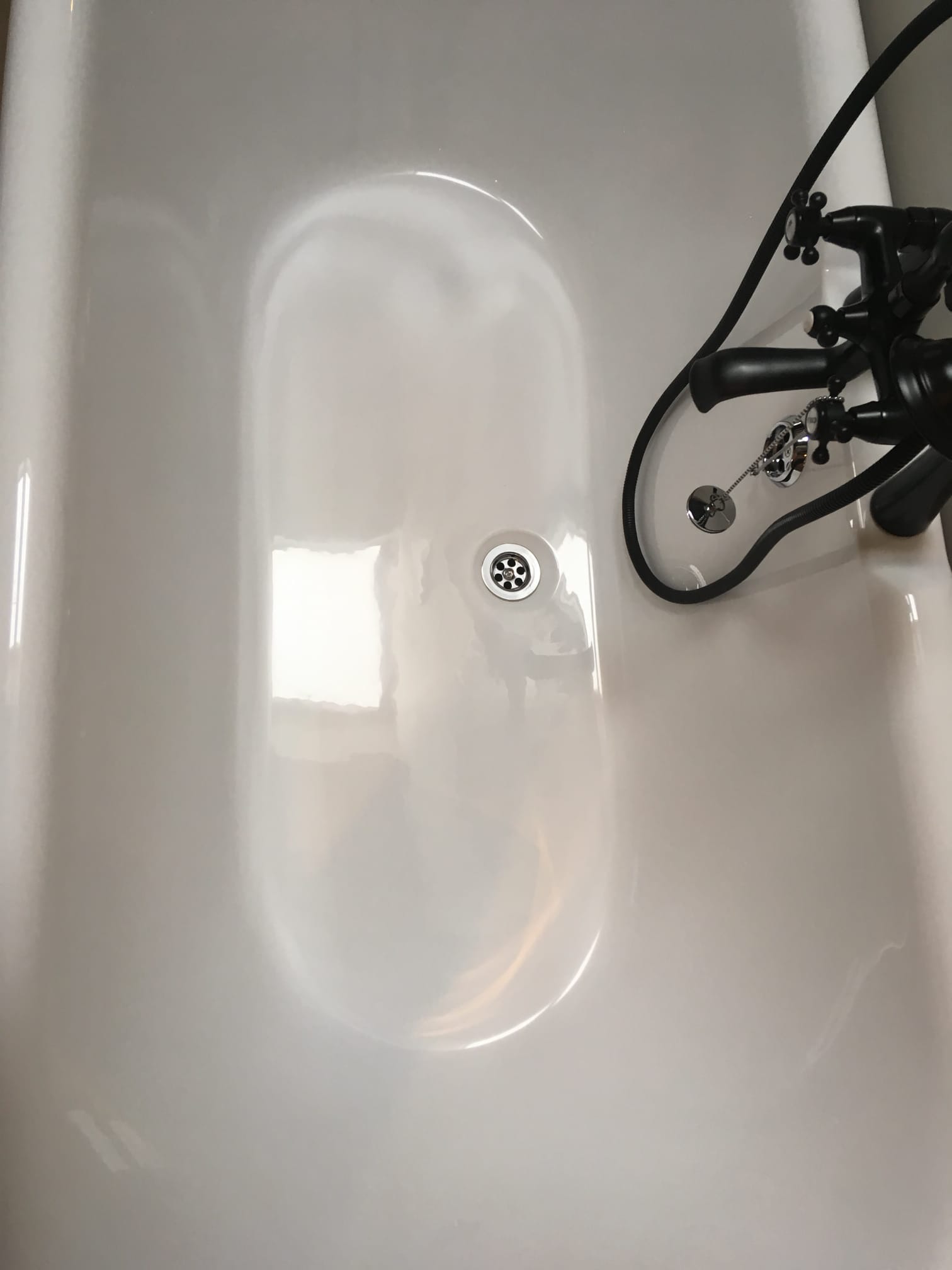 Modern bath with black fixtures fully restored